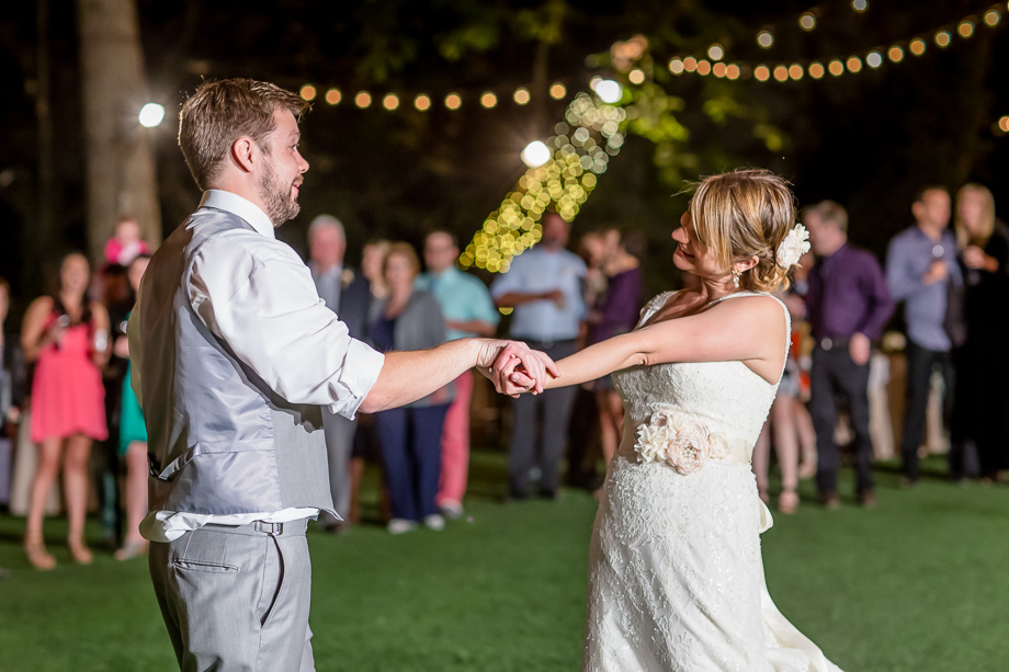 bride and groom outdoor nighttime reception string lights