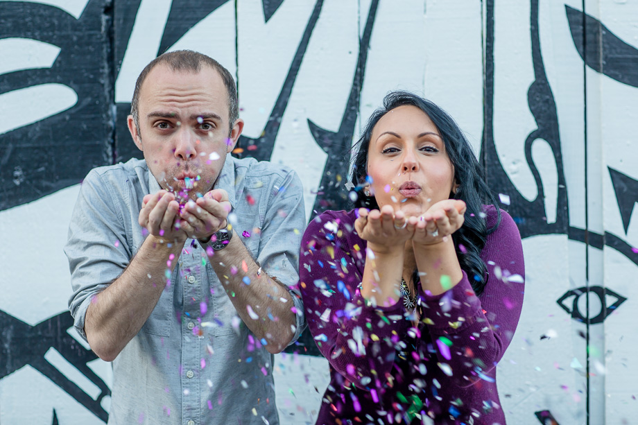 confetti engagement photo in front of the graffiti wall at san francisco clarion alley