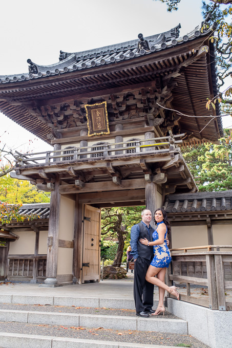 engagement photo at entrance of Japanese gardens