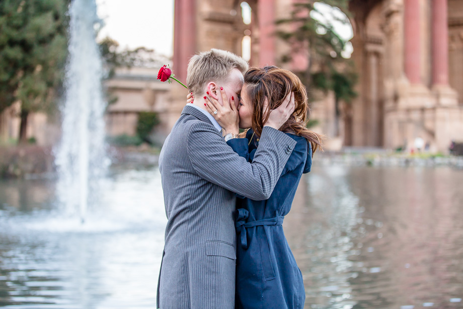 romantic kiss in front of fountain and pond
