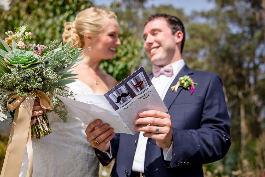 bride and groom looking at wedding invitations
