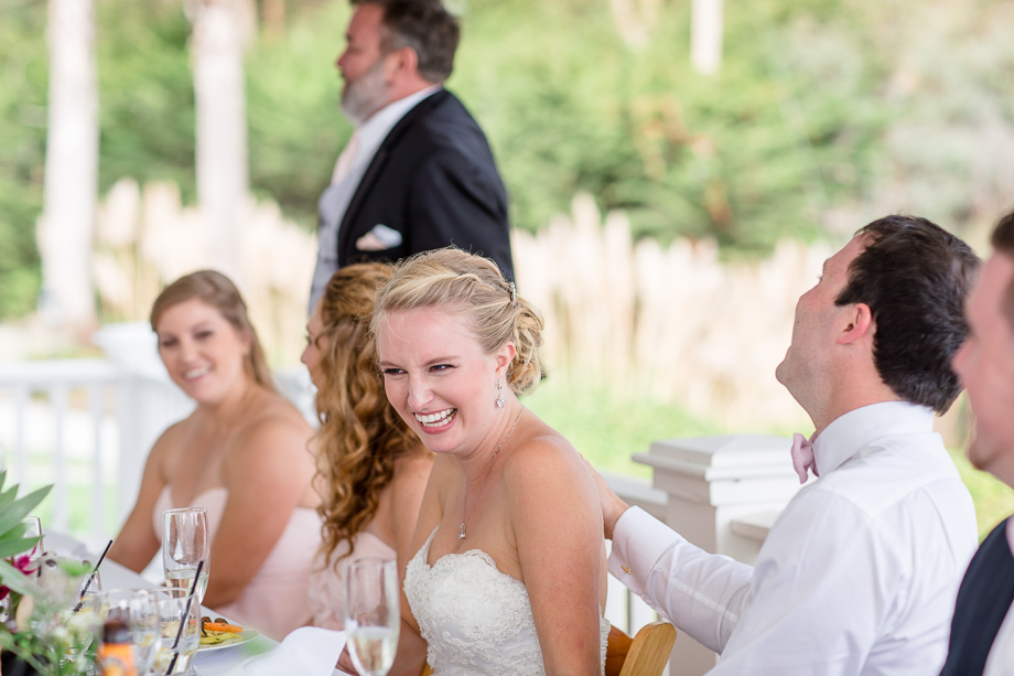 bride laughing at futnny wedding toast