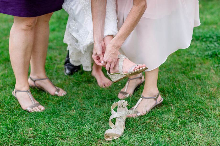 fixing bride's shoes