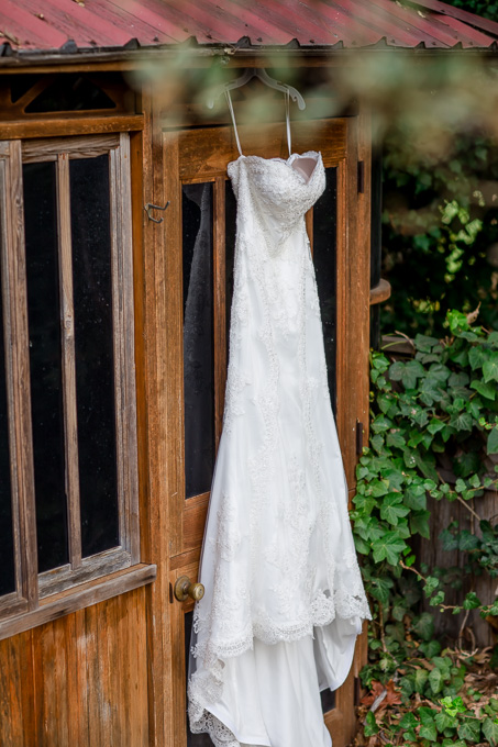 wedding dress hanging on doorway