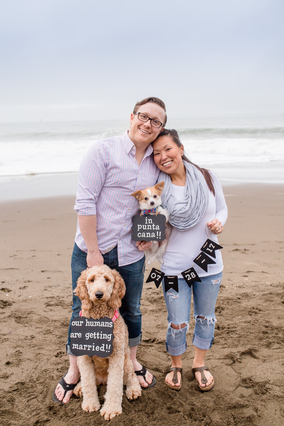 cute save the date photo at baker beach with two puppies
