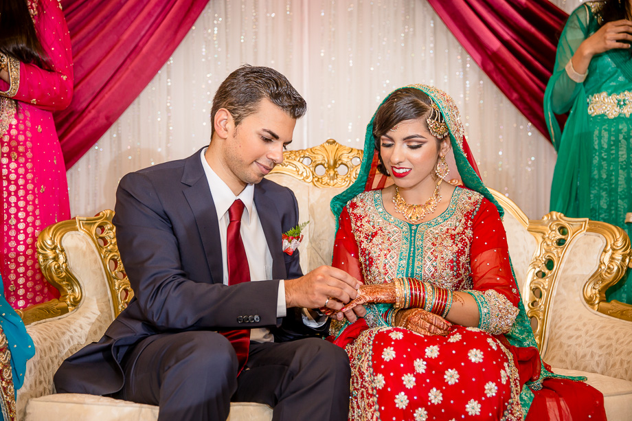 Pakistani Muslim engagement ceremony putting on the ring