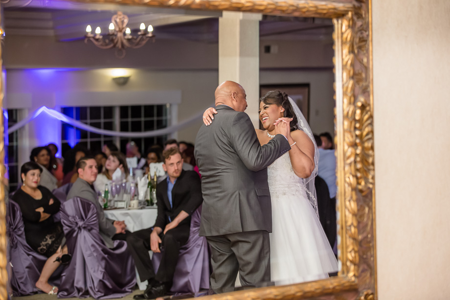 father daughter dance at wedding framed through a mirror