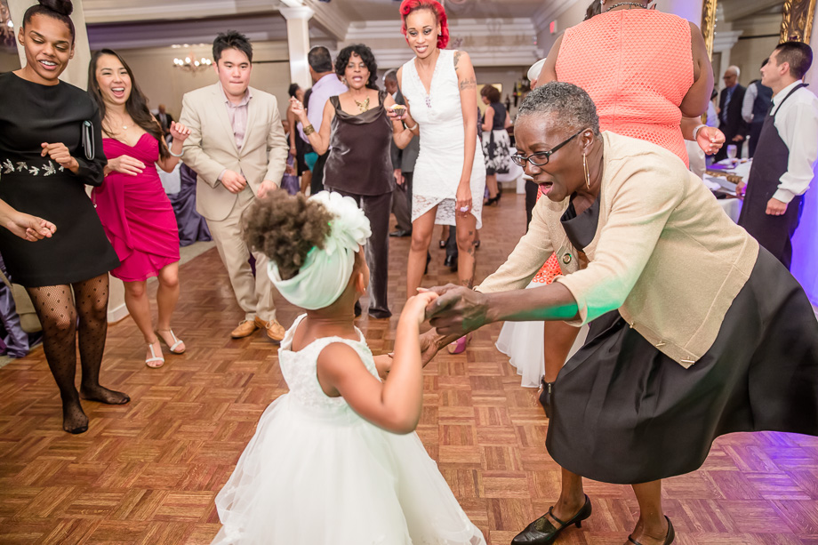grandma dancing with little girl on wedding dance floor