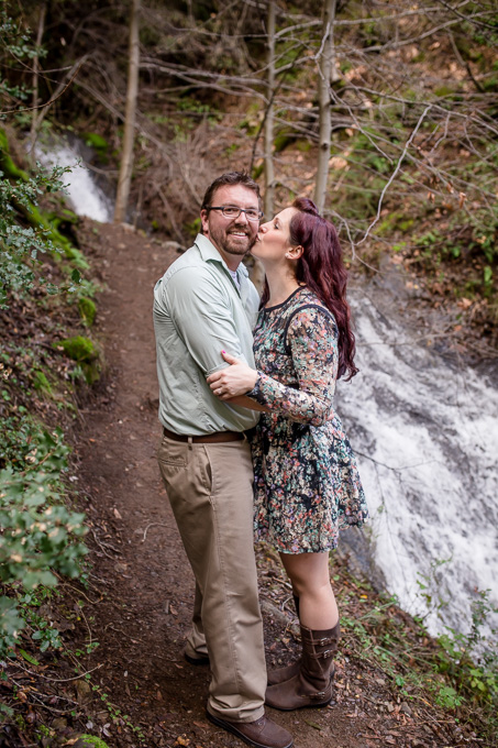 engagement photo next to small waterfall