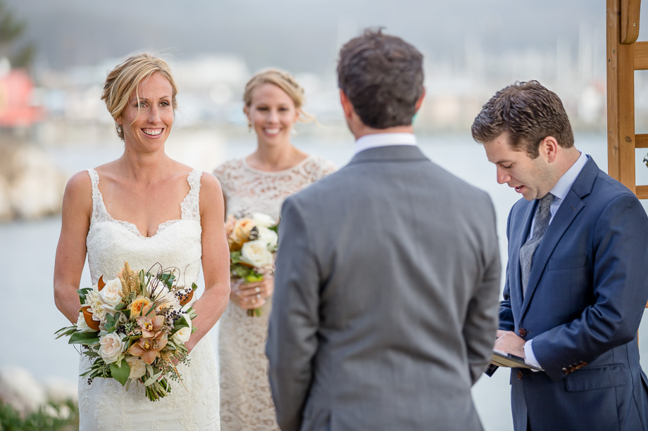 bride smiling at groom during wedding ceremony in Half Moon Bay
