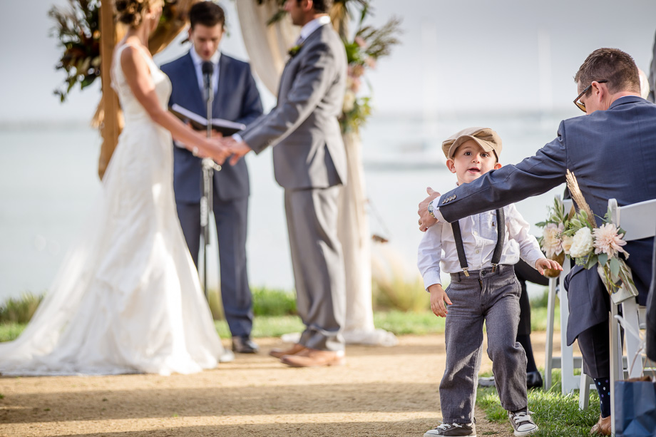 kids will be kids - funny photo of the ring bearer not paying attention during the wedding ceremony