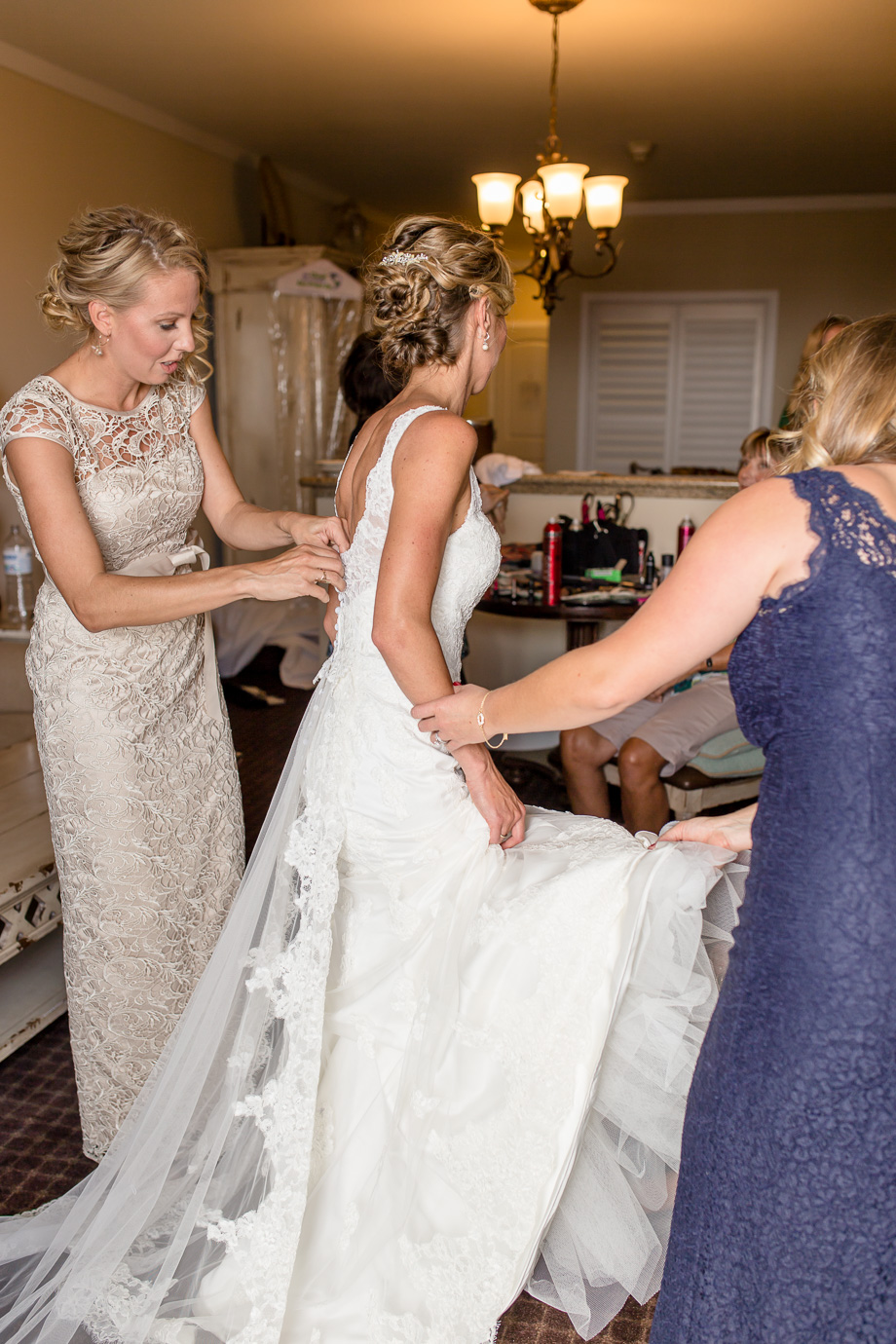 Bride getting into her dress at the Oceano Hotel and Spa