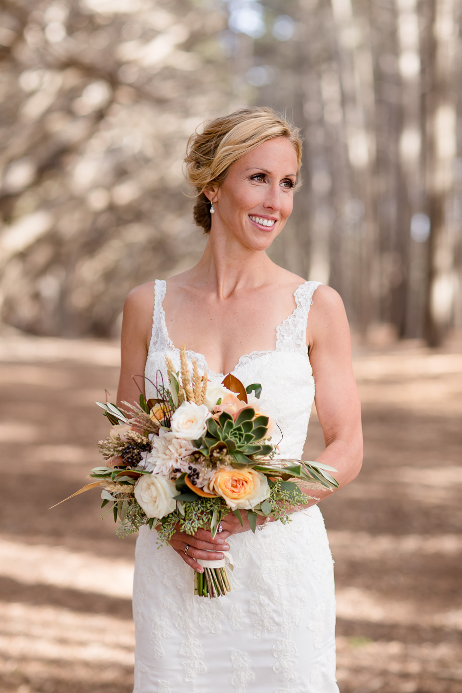 gorgeous bride with an elegant lace wedding gown and a succulent bouquet in a magical forest - Half Moon Bay wedding photographer