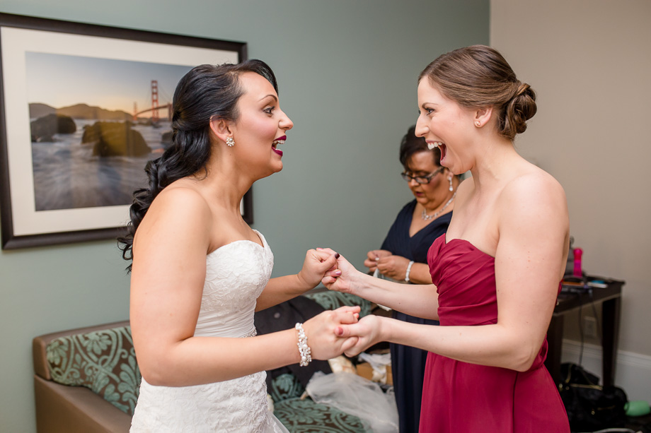 a cute moment between the bride and her bridesmaid, at the WorldMark before the San Francisco City Hall wedding