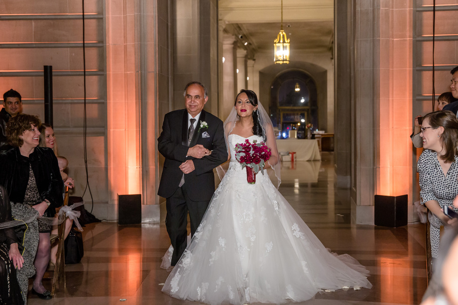 bride walking down the asile at San Francisco City Hall