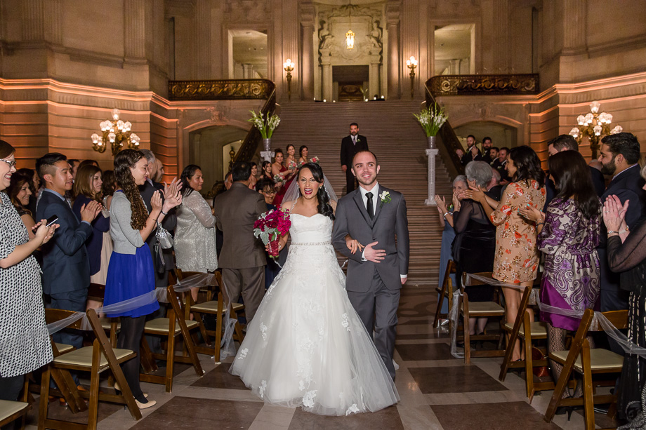 bride and groom walking down the aisle as husband and wife - sf city hall wedding