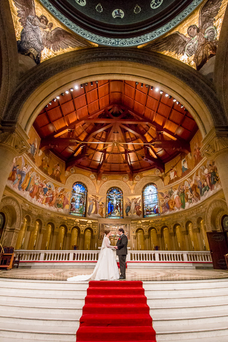 Bride and groom standing at the Stanford Memorial Church altar