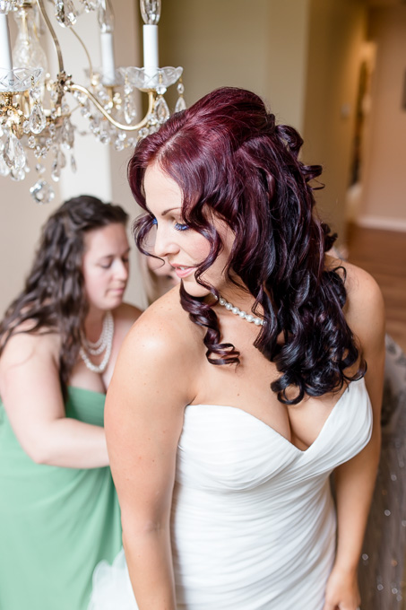 bridesmaids helping bride with her dress
