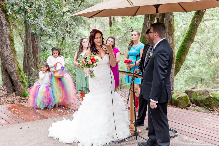 bride giving her vows under an umbrella