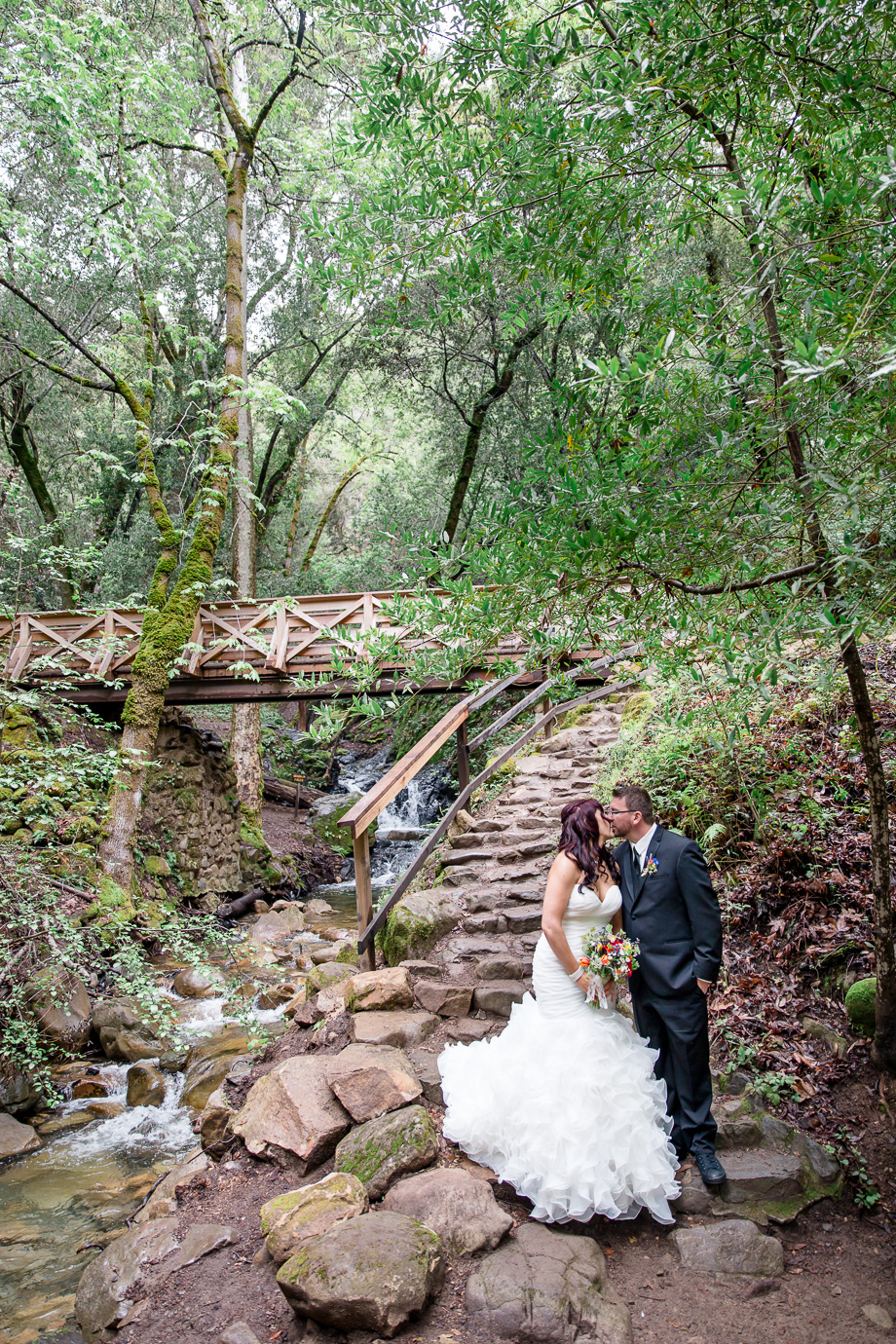 bride and groom wedding portrait by the waterfall in the woods at California Uvas Canyon County Park