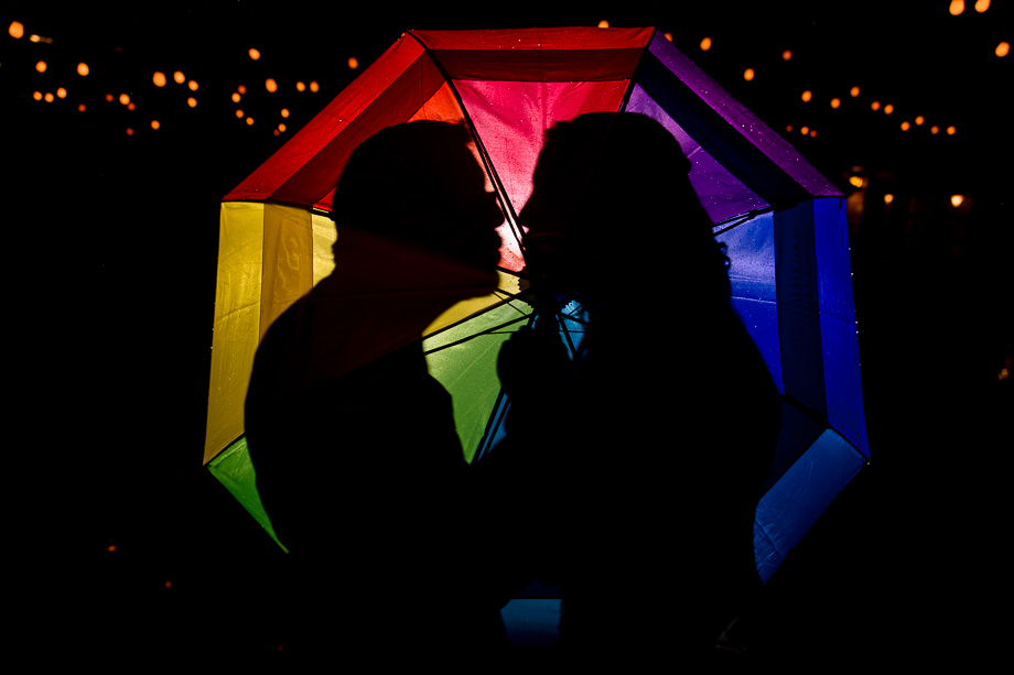 a night shot idea with colorful umbrella for a rainbow themed wedding