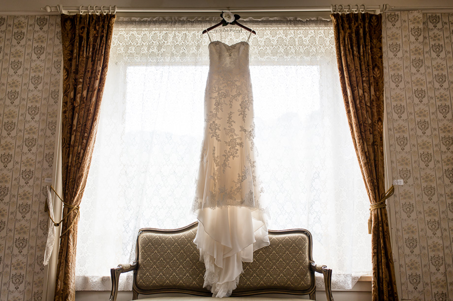 wedding dress hanging on the mansion window
