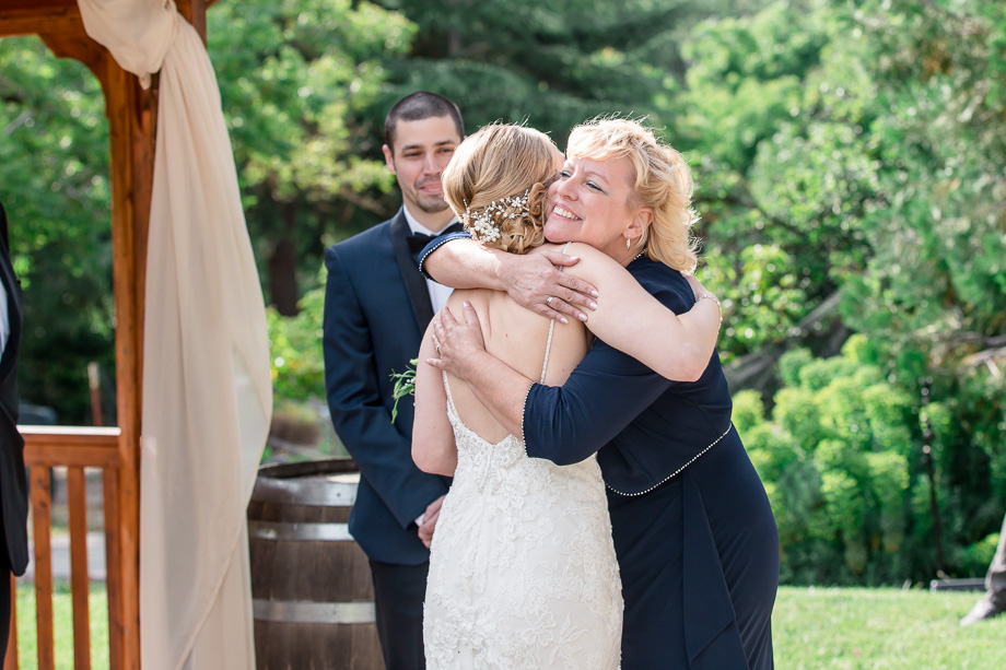 mom hugging the bride right before the ceremony