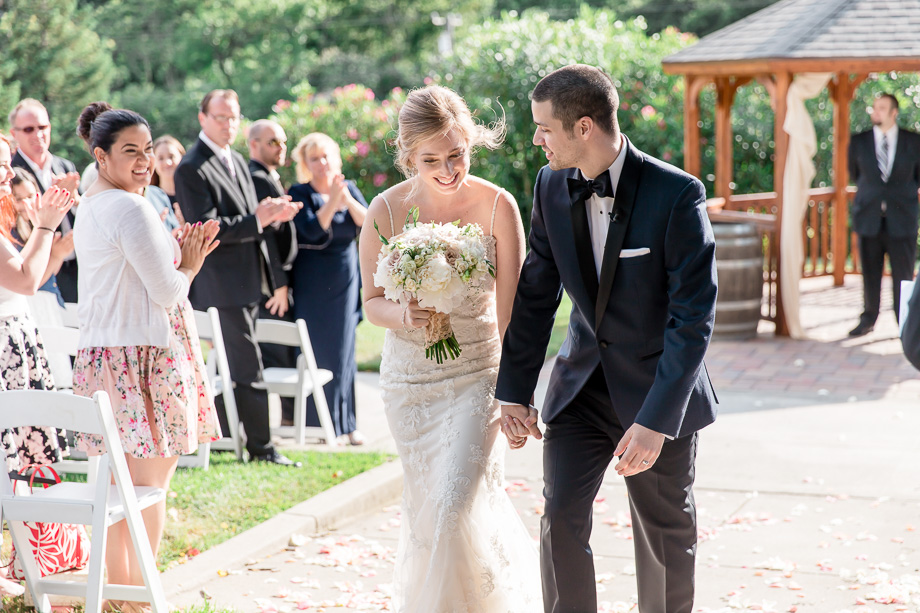 bride and groom walking down the aisle together - happy recessional