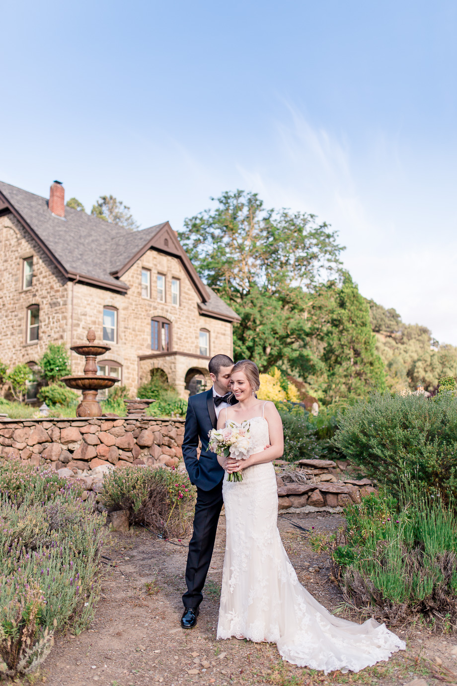 Bride and groom in front of the Elliston Vinyards fountain and manor for their wedding