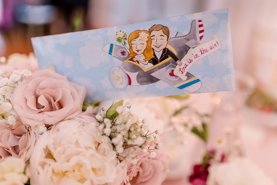 travel-themed wedding guest favor - paper plane in an envelope