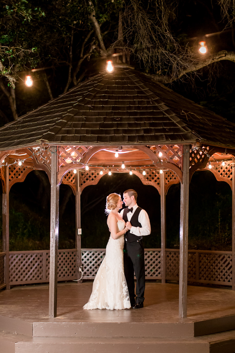 a night shot of the bride and groom at the Elliston Vineyard gazebo by the reception site