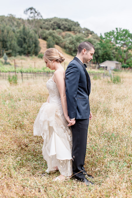 the romantic moment before bride and groom see each other on the open field