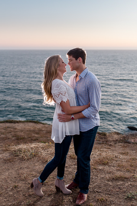 sunset backlit engagement photo on a cliff by the ocean in Sausalito