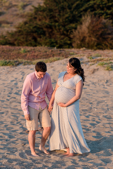 fun and candid maternity photo on the beach