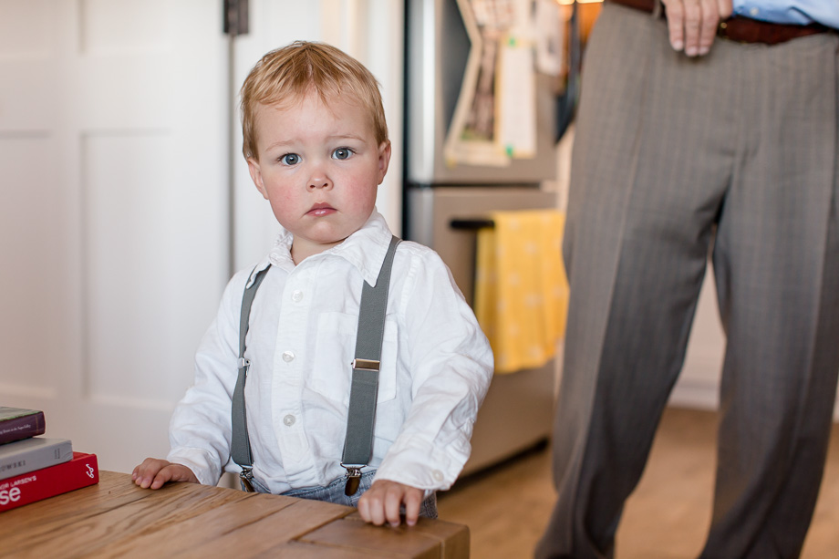 cute little ring bearer holding his serious face
