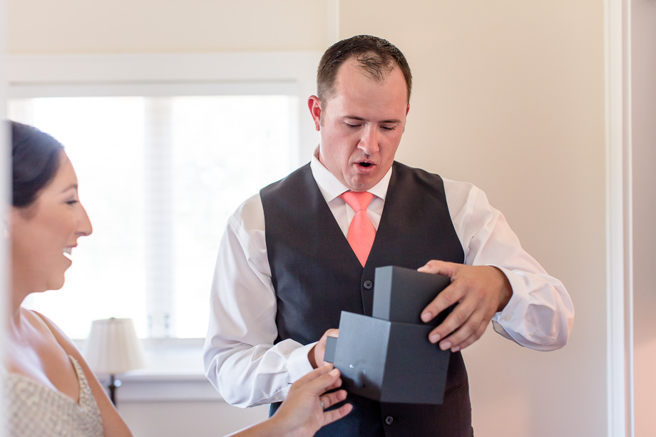 the moment when the groom opens his surprise gift from the bride