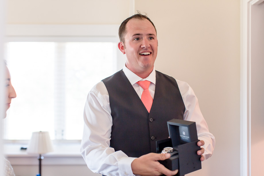 groom loves his wedding gift from the bride