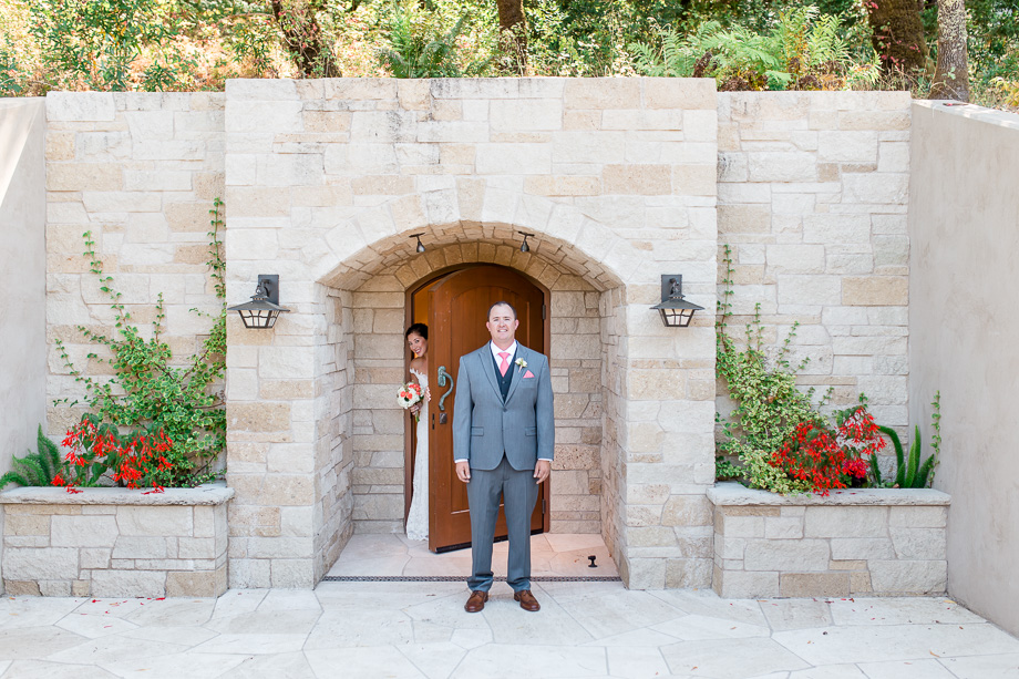 bride and groomdoing their first look in front of a Napa Valley private wine cellar