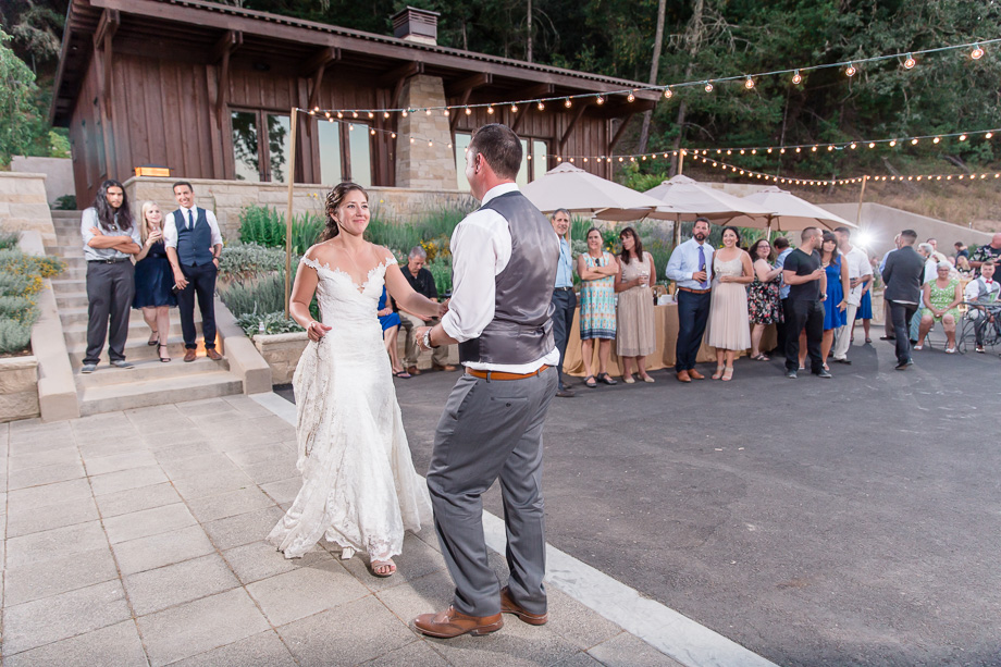 romantic first dance under the cafe string lights - St Helena winery wedding