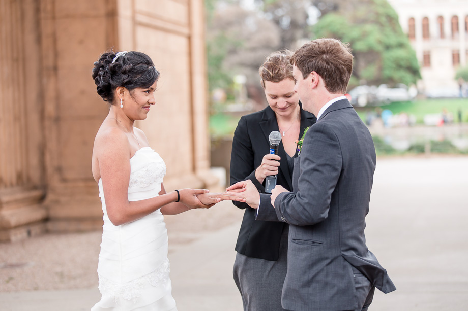 exchanging wedding rings at the Palace of Fine Arts ceremony