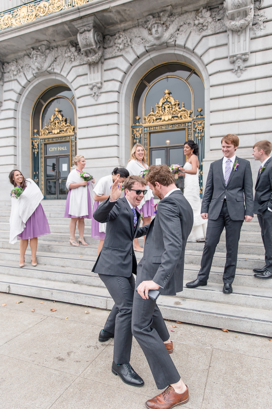 wedding party having fun in front of San Francisco City Hall