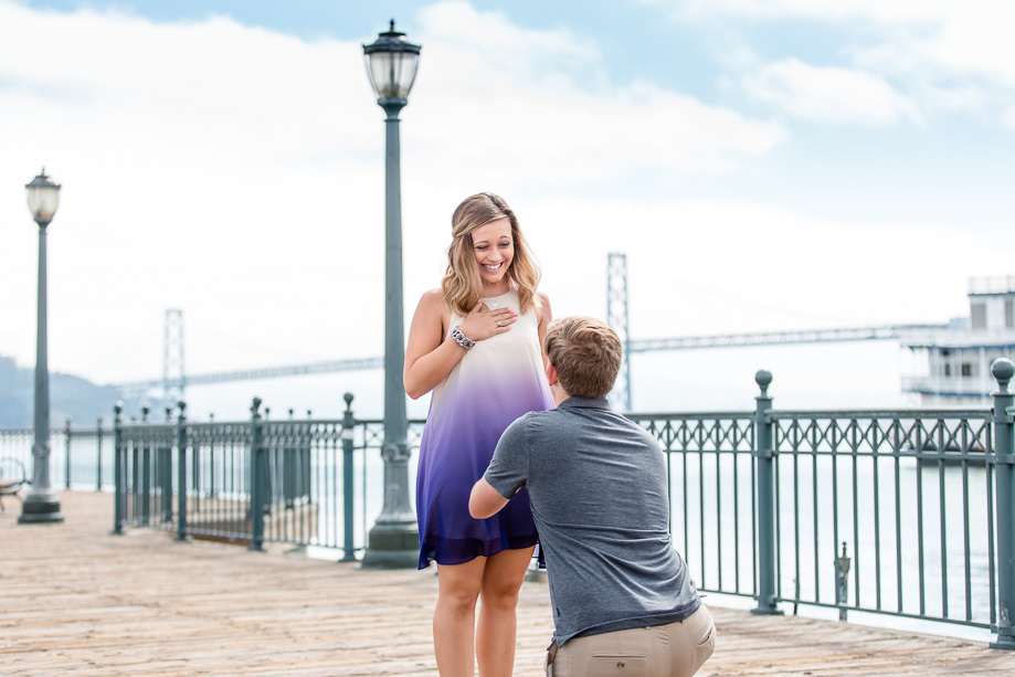 surprise marriage proposal at wooden pier seven san francisco bay bridge backdrop