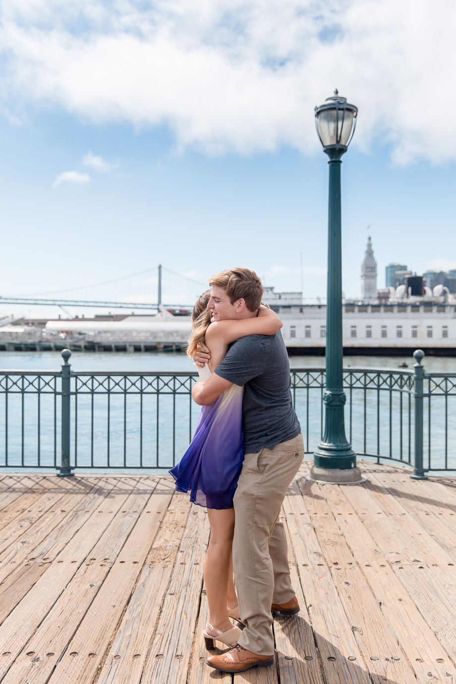 a warm hug after the sf surprise marriage proposal on the pier