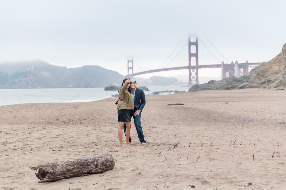 moments before the surprise proposal on Baker Beach with the Golden Gate Bridge background