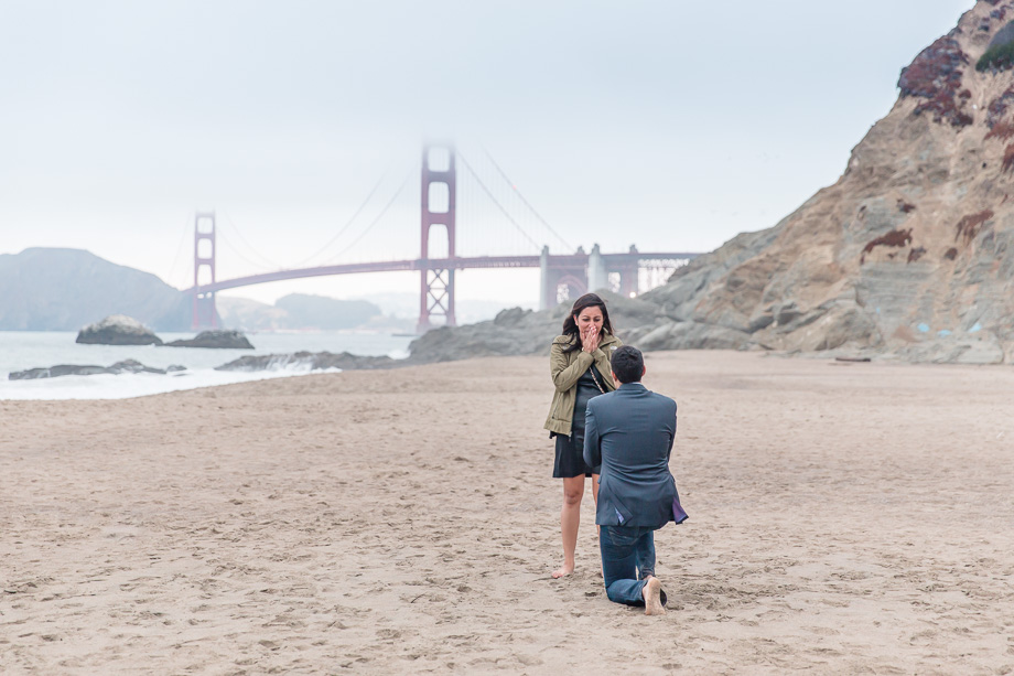 Baker Beach surprise engagement proposal with Golden Gate Bridge in the background