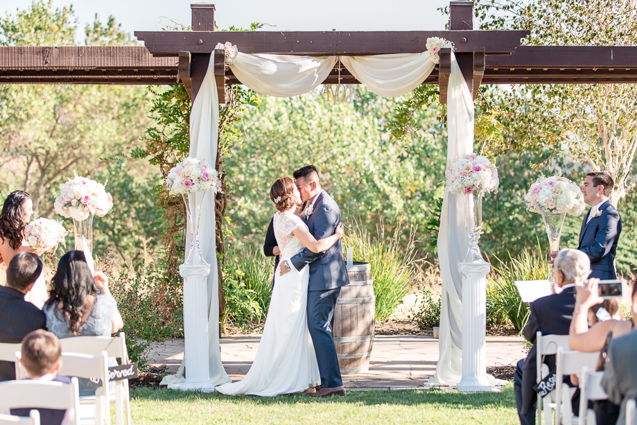 bride and groom first kiss as husband and wife at their Livermore winery wedding