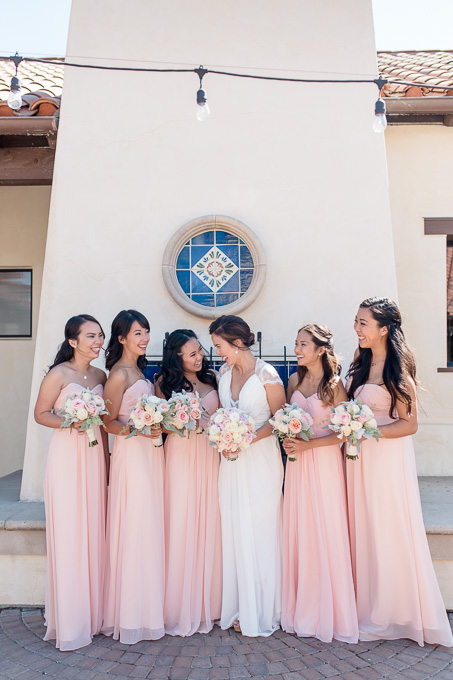 pink and white winery wedding - bride and her bridesmaids in their pink pastel flowy dresses