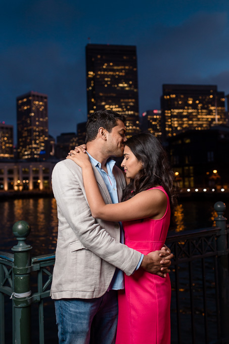 night shot of the couple in front of San Francisco skyline
