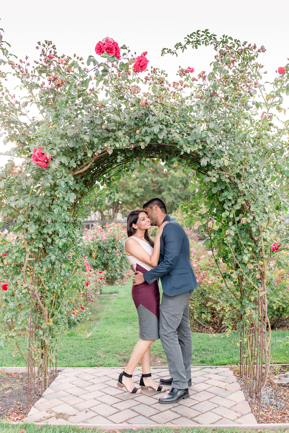 bay area surprise proposal - kissing under the rose arch