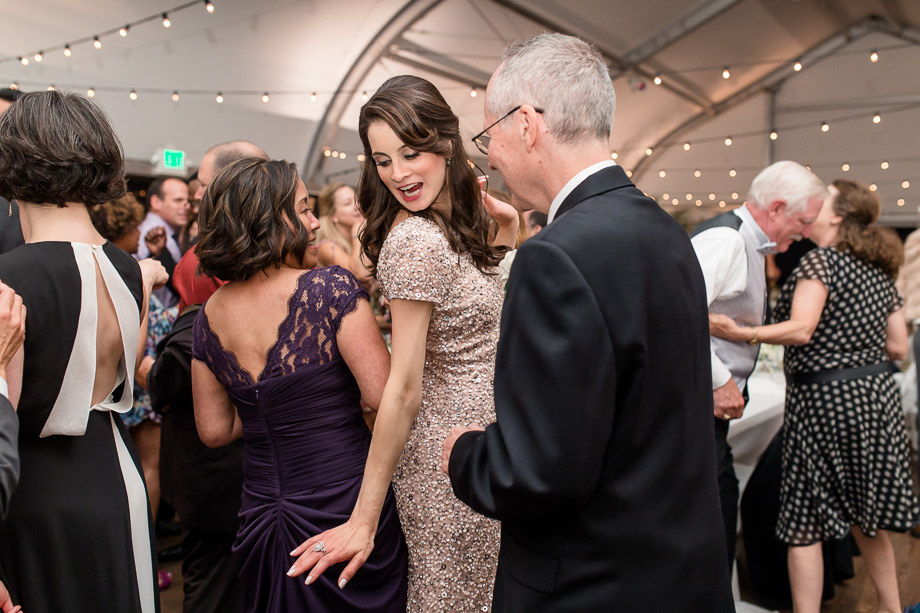 a cute photo of bridesmaid dancing with brides parents